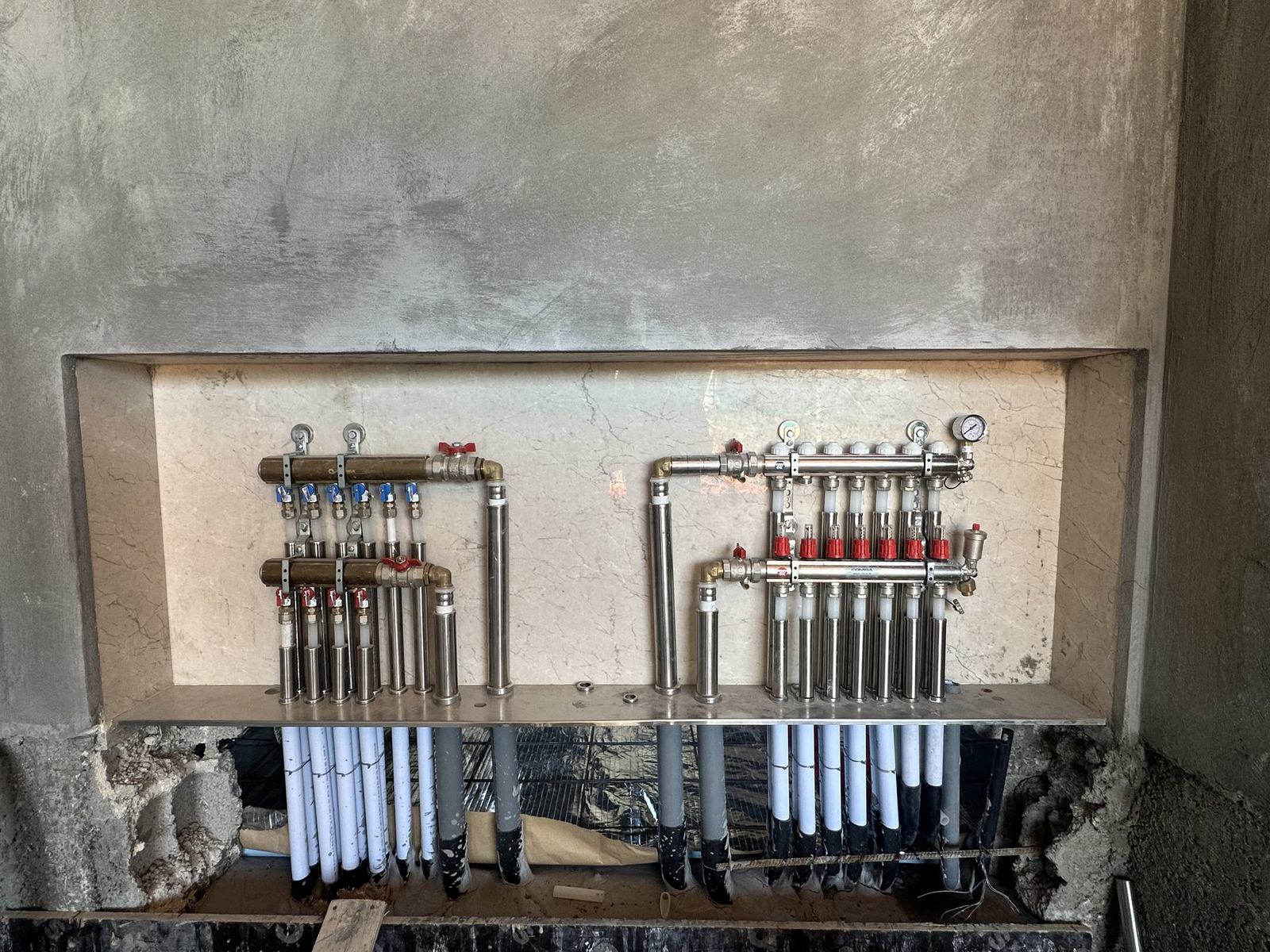 Twin underfloor heating manifolds in a wall cabinet