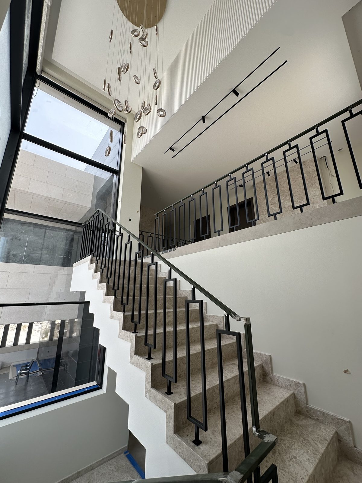 Marble staircase with black steel balustrade