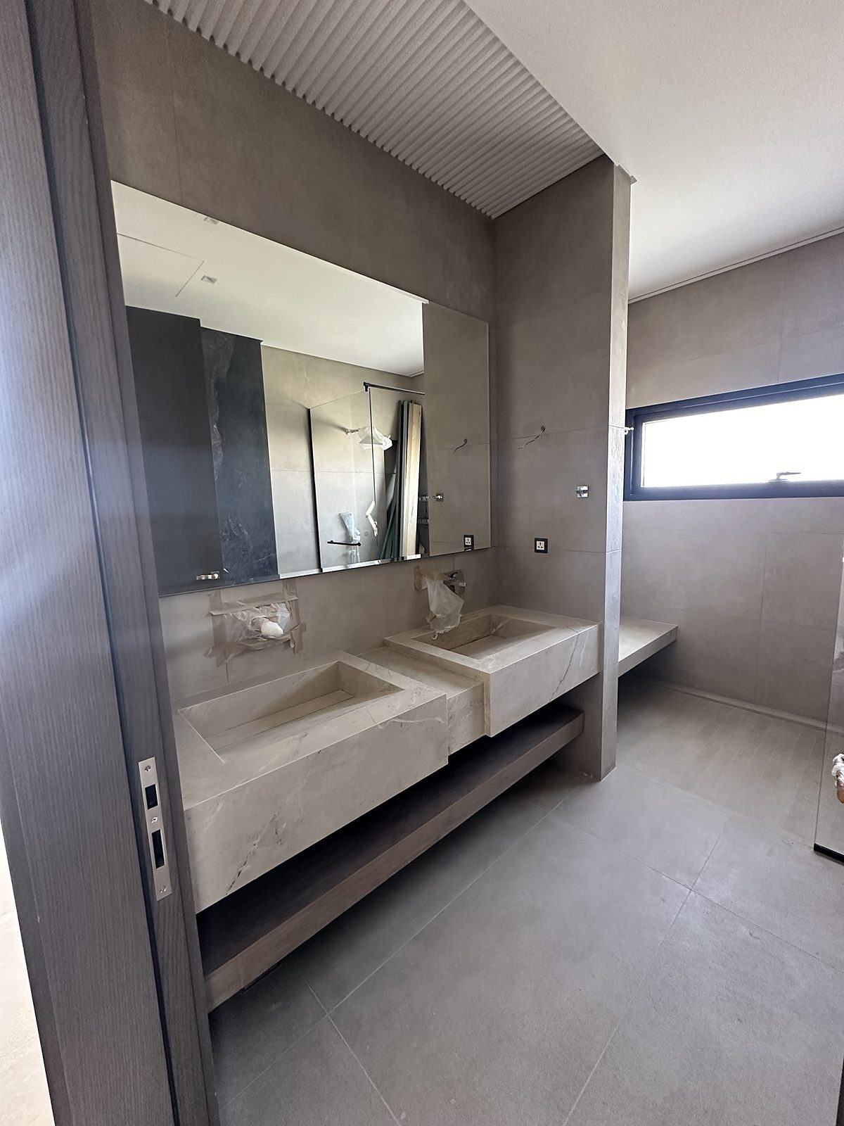 Twin stone basins with fluted ceiling