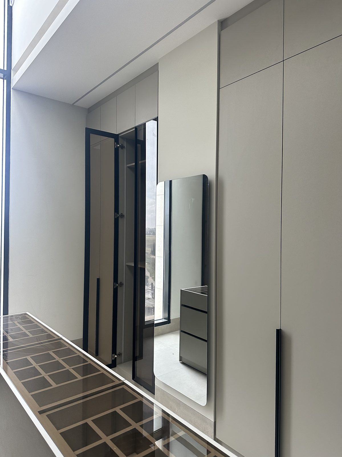 Dressing area with glass cabinets and jewellery island