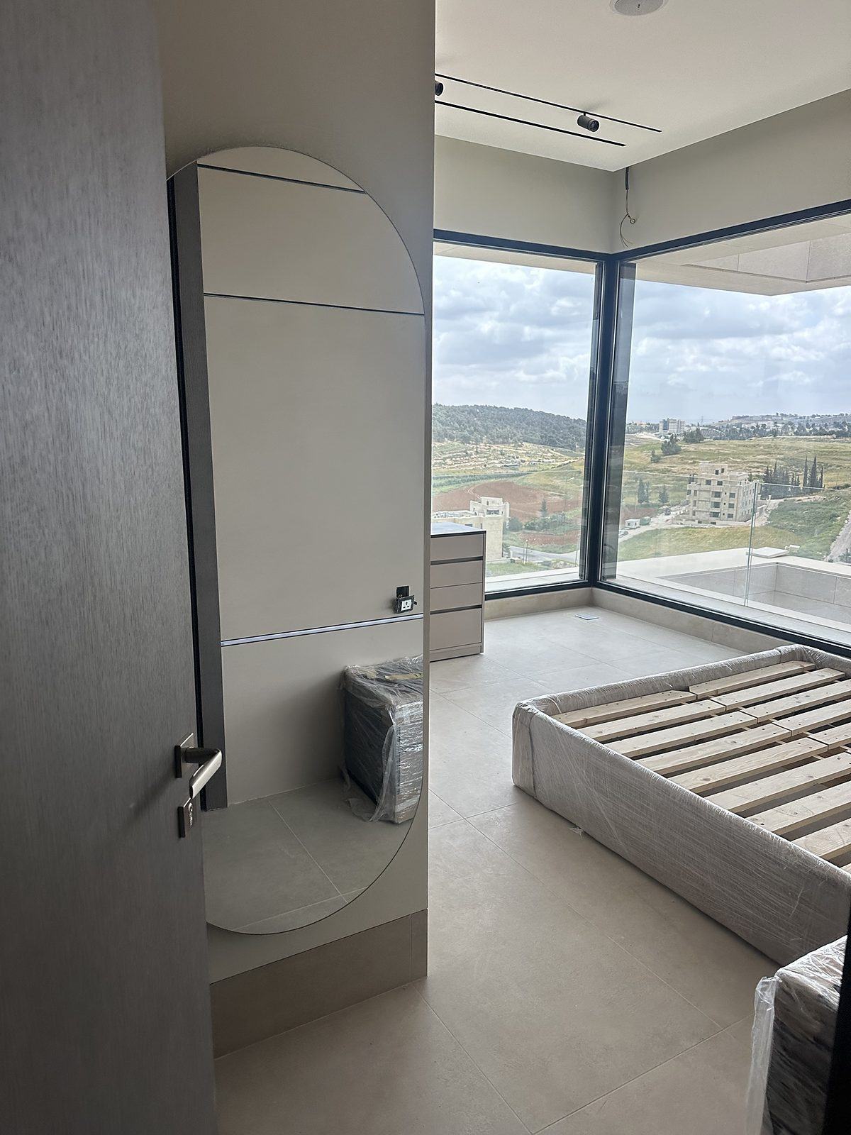 Bedroom with corner glazing and valley view