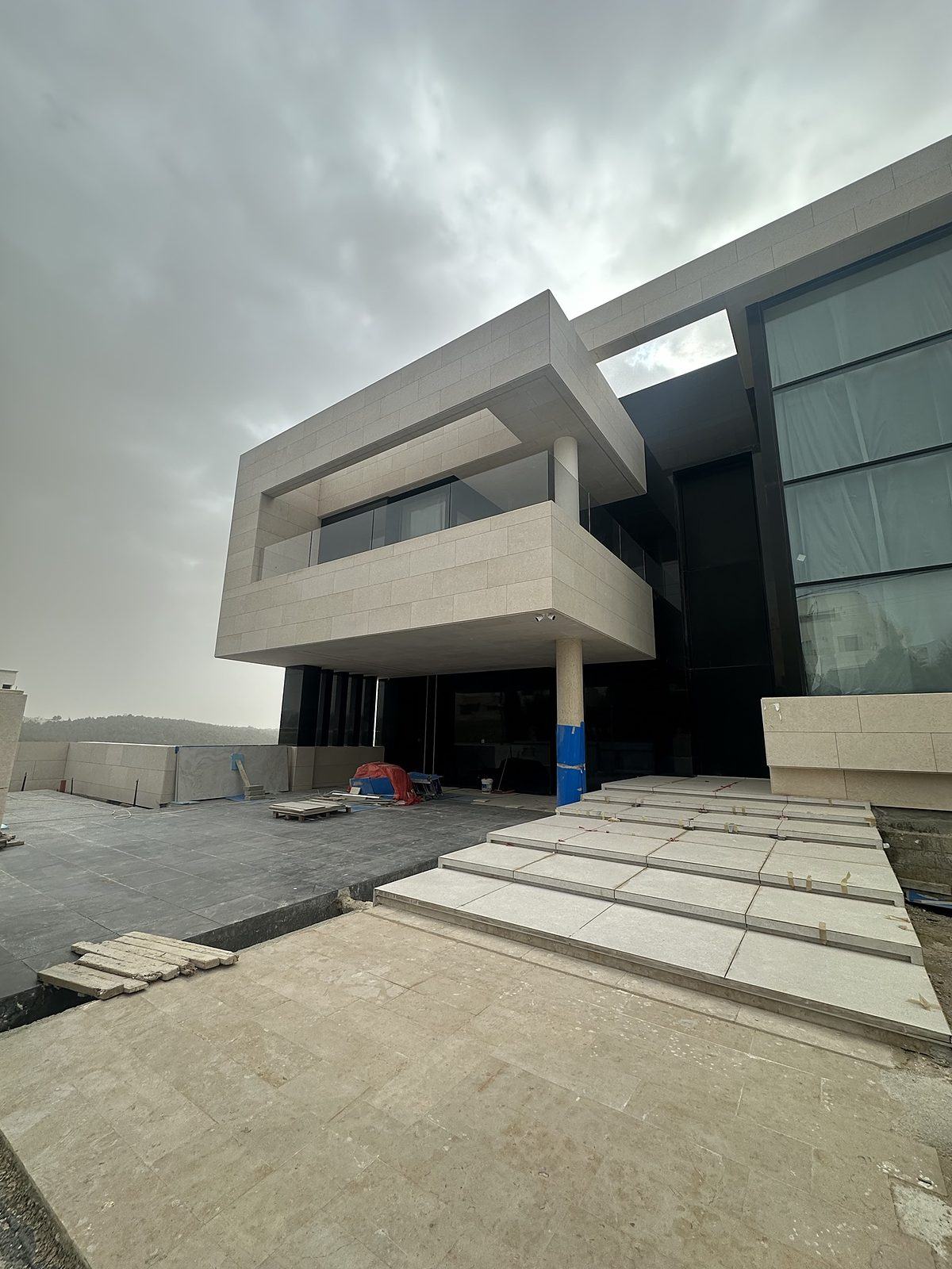 Cantilevered stone facade with glazed entrance