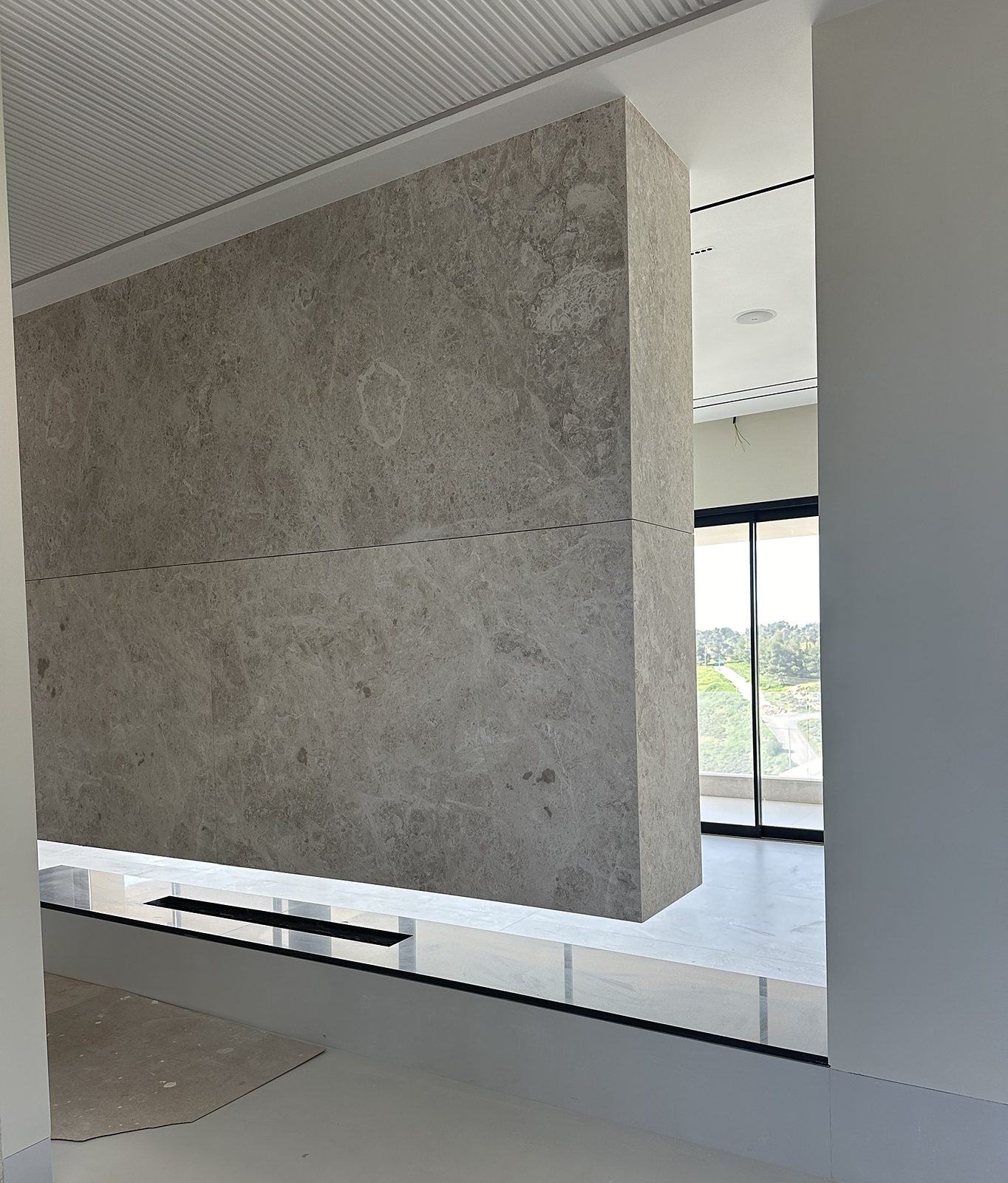 Floating marble volume over a glass plinth