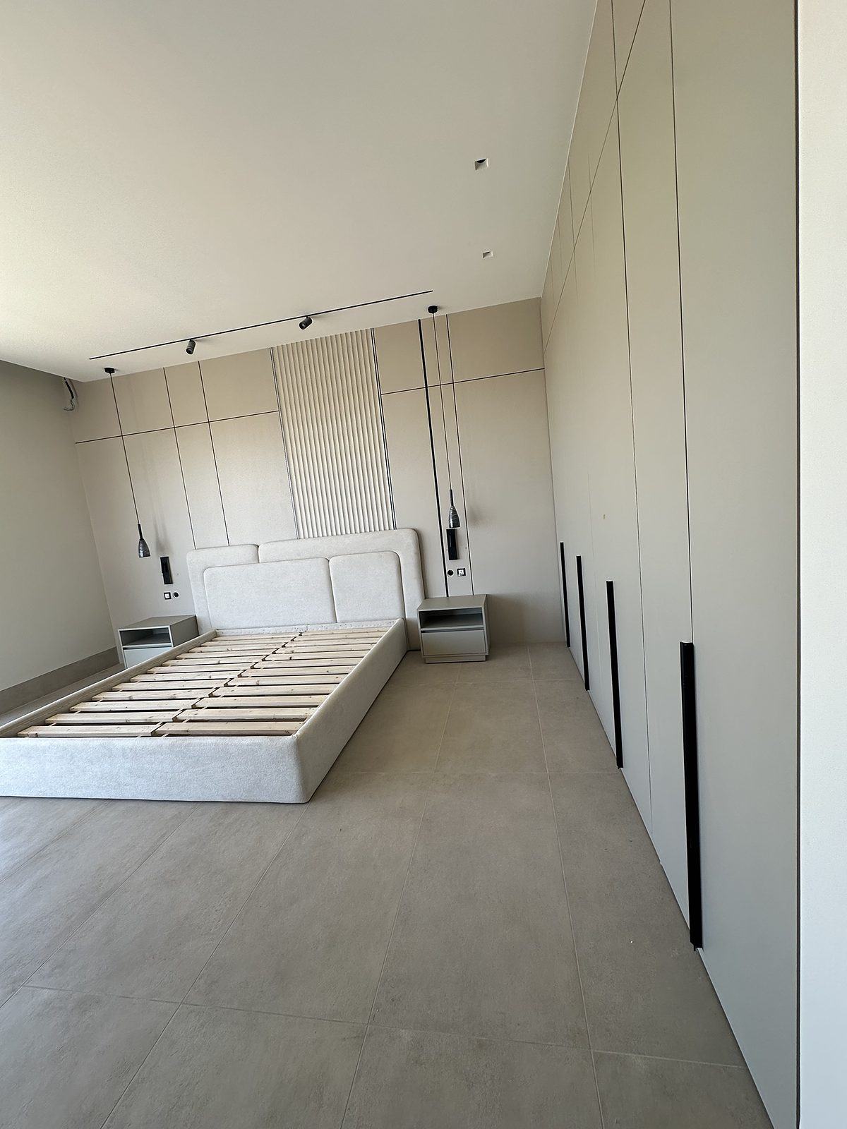 Master bedroom with fluted headboard wall