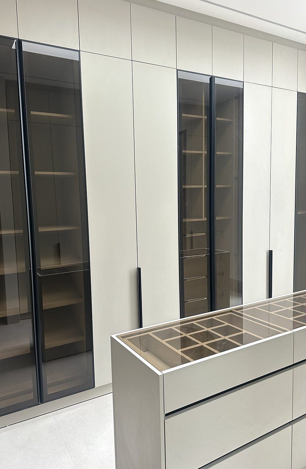 Walk-in wardrobe with smoked-glass doors