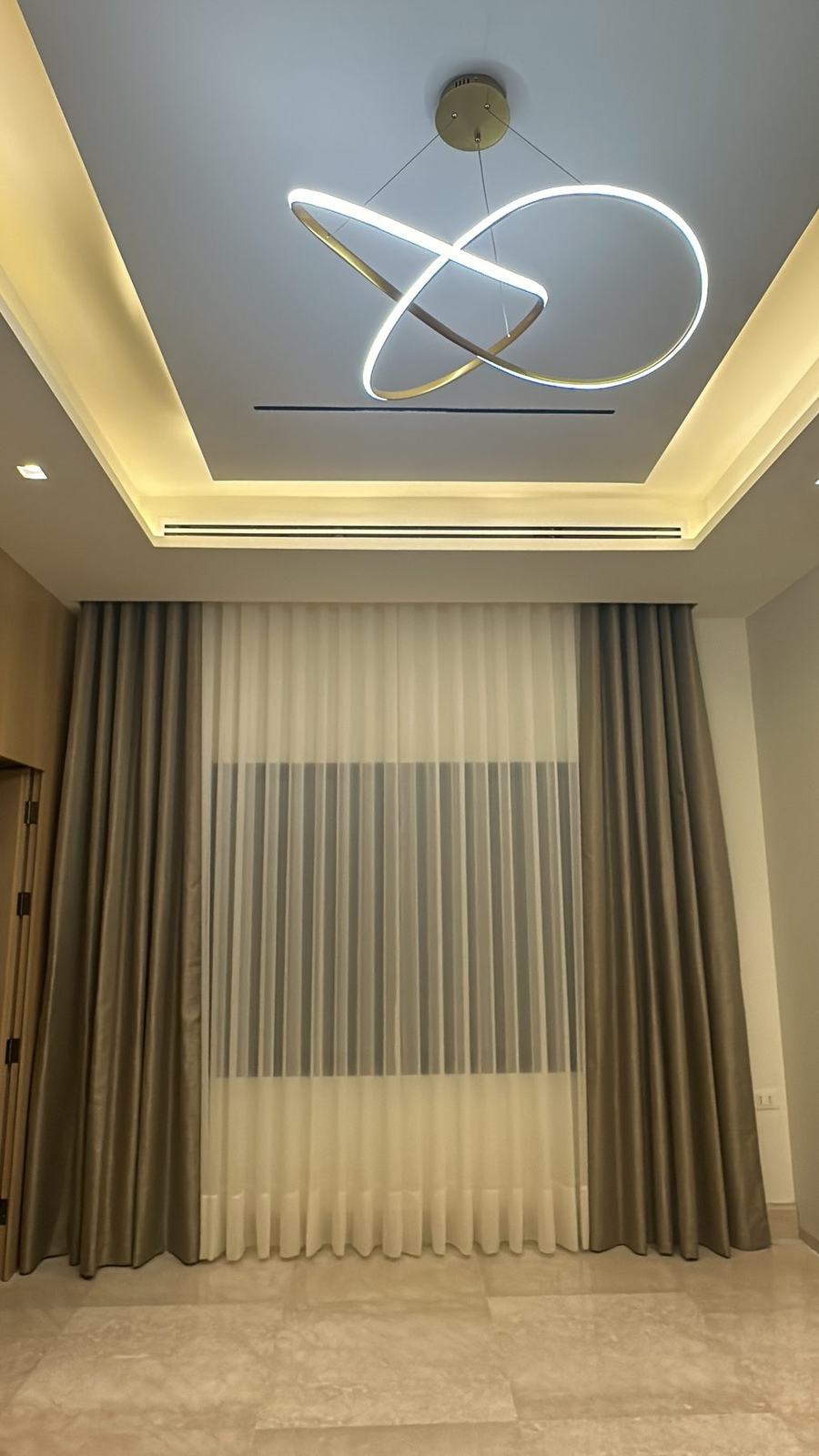 Sculpted ceiling light and drapery