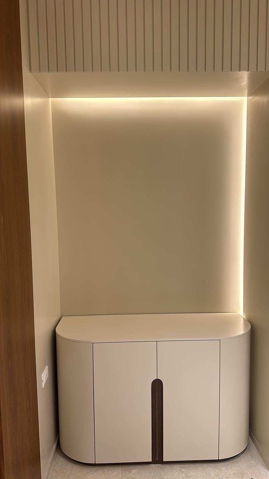 Lit niche with curved cabinet
